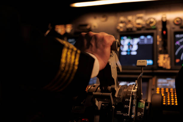 Male pilot throttling engine to takeoff and fly jet Male pilot throttling engine to takeoff and fly jet in cockpit, flying plane using dashboard command and control panel buttons. Looking at windscreen and radar compass, taking off. Close up. throttle stock pictures, royalty-free photos & images