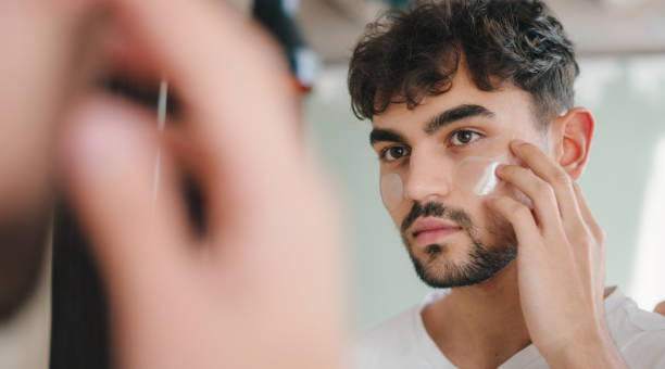 istock Mirror reflection head shot applying facial cream in bathroom satisfied doing personal hygiene. Beauty routine. Beauty treatment. Facial skincare. Skin care routine. 1439915872