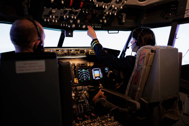 istock Female pilot assisting captain to takeoff and fly airplane 1439915955