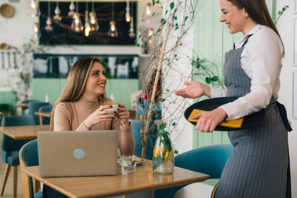 istock woman ordering food in lounge bar 1439915992