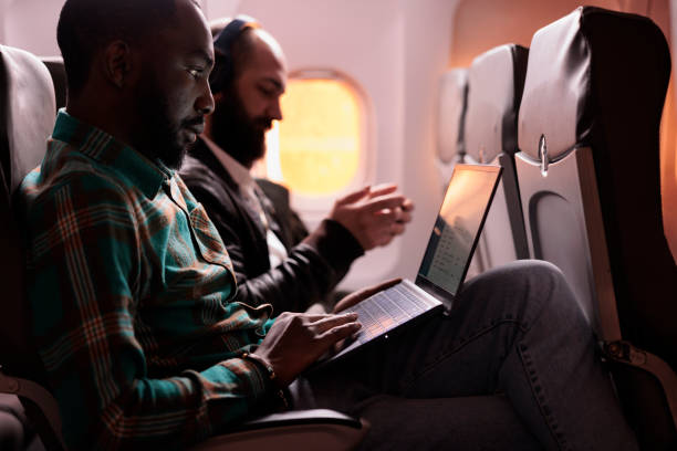 istock African american male freelancer working on laptop during sunset flight 1439916107