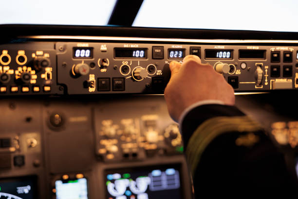 istock Male captain fixing altitude and longitude level on dashboard 1439916207