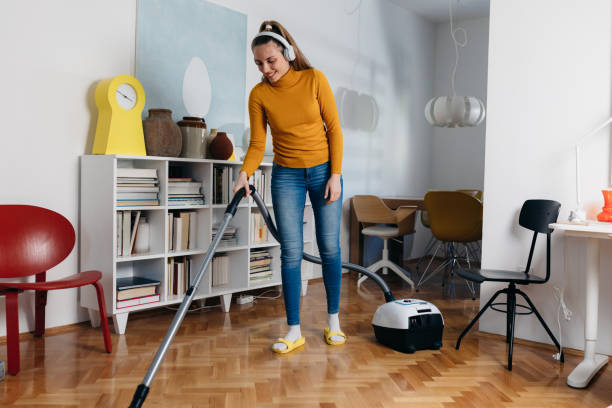 istock woman vacuuming floor at home 1439916284