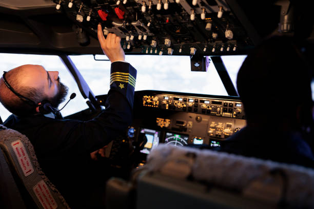 istock Male captain pushing buttons to start power on dashboard control 1439916934