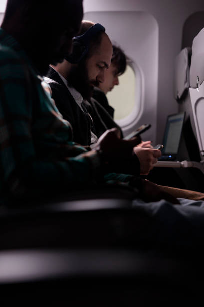 istock Multiethnic passengers flying in economy class with airplane 1439916966