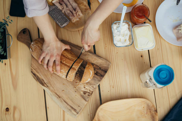istock top view of woman cutting bread 1439917194