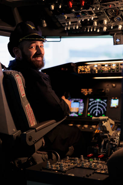 istock Portrait of smiling male captain flying airplane with panel command 1439917222
