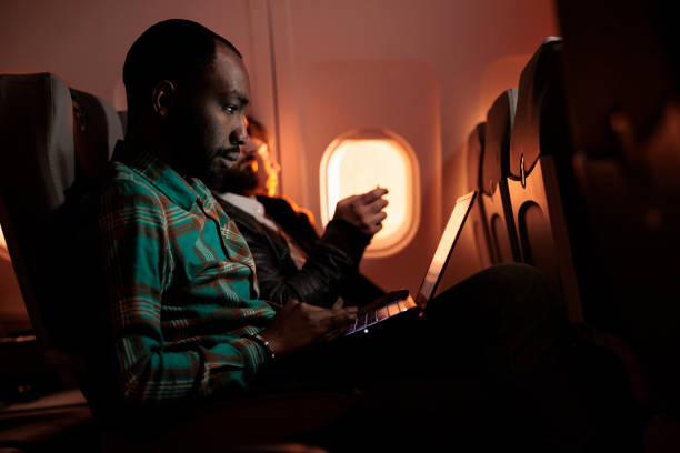 istock African american freelancer working on laptop during sunset flight 1439918328