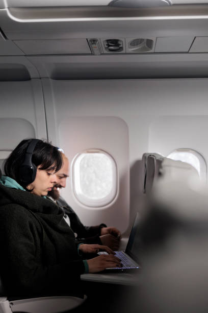 istock Tourists couple working on laptop and using mobile phone 1439918363
