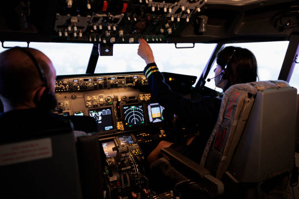 istock Team of aircrew member and captain using power switch on cockpit dashboard 1439918465
