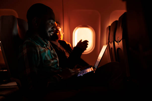 istock Male passenger browsing internet on laptop and flying abroad 1439918529