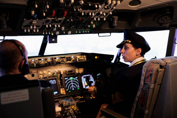 istock Woman copilot in uniform flying airplane with cockpit command 1439918639