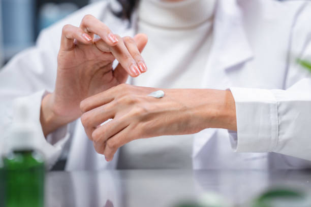 istock Beauty eco cosmetic research and development concept, Scientist or Pharmacist applying moisturizer lotion on her hand for efficacy testing of natural organic skincare products in laboratory 1439921744