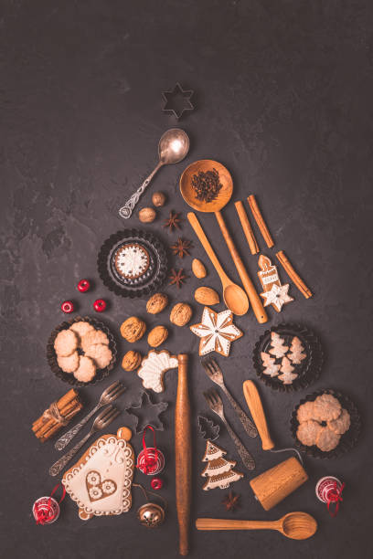 istock Holiday, celebration and cooking concept - Christmas tree made from gingerbread cookies and baking ingredients 1439924780
