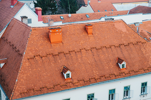 Orange colored tiles on rooftops on town houses, cityscape on a winter day