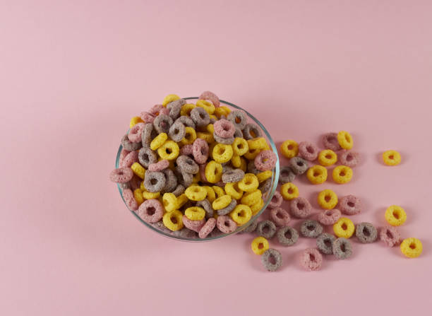 istock cereal breakfast rings on a pink background in a plate and scattered nearby 1439931254