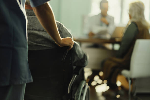 istock Assisting disabled patient in hospital! 1439931522