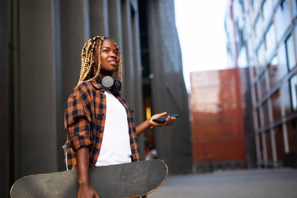 istock Beautiful African woman with skateboard. 1439932946