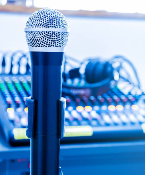 istock Microphone on tripod with mixer background in sound control room. 1439933286