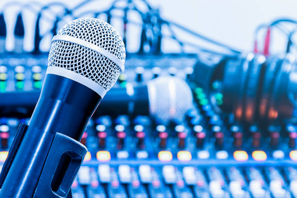 istock Microphone on tripod with mixer background in sound control room. 1439933288