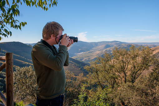 Tourist taking photos of the landscape in the Douro Valley