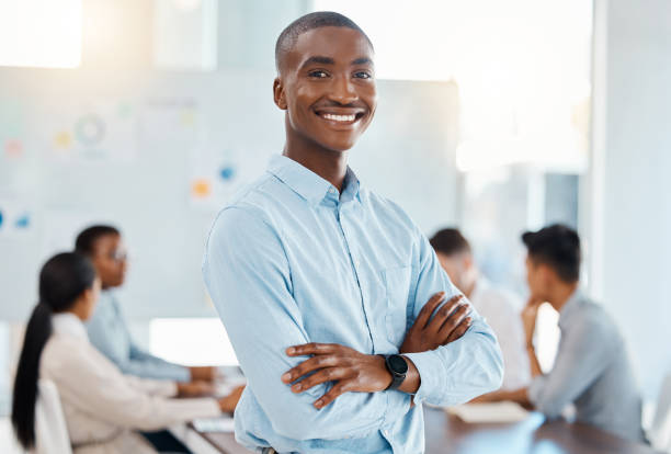 istock Corporate manager, meeting leader and management in training workshop with employees, working on startup company coaching and smile for success. Portrait of African businessman in team seminar 1439935753