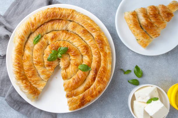 istock Traditional Turkish pastry with spinach. (Turkish Name: Ispanakli Kol Boregi, Bosnak boregi). Handmade pastry with spinach filling. 1439937977