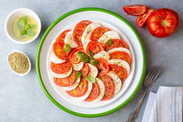 istock Italian caprese salad with sliced tomatoes, mozzarella, basil, olive oil 1439938204