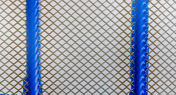 Close up of wire mesh with blue frame and white background