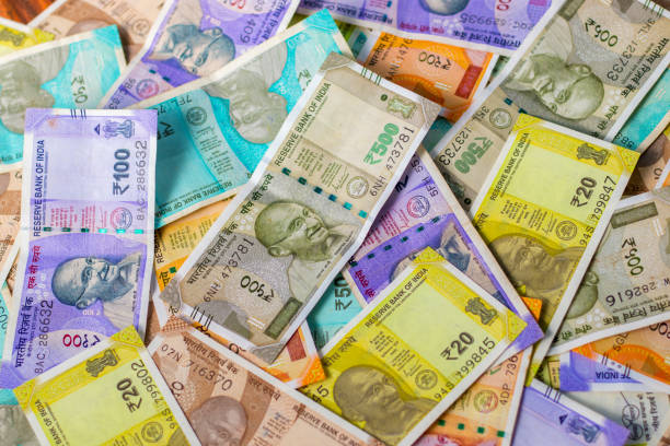 istock Indian currency notes are scattering on the floor. 1439940589