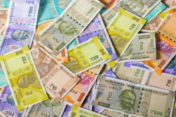 istock Indian currency notes are scattering on the floor. 1439940594