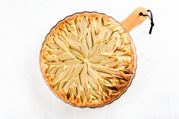 istock Overhead view on homemade rhubarb geometric pie over white concrete table background. Delicious home baked seasonal pastry 1439942501