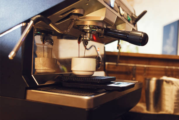 istock Close up of espresso pouring from coffee machine 1439942505