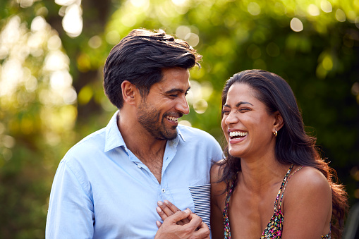 Portrait Of Loving Couple Outdoors In Garden Or Countryside