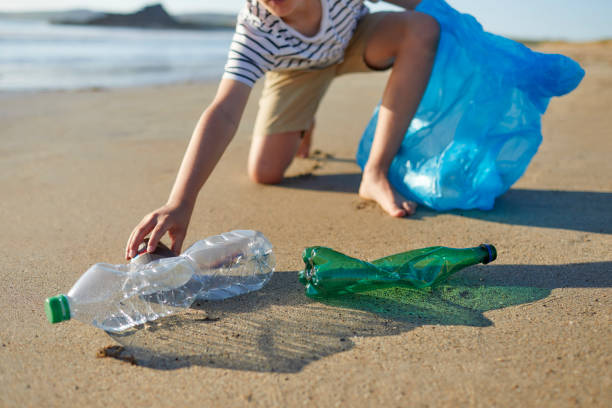 istock Child activist picking up disposable coffee cup 1439946147
