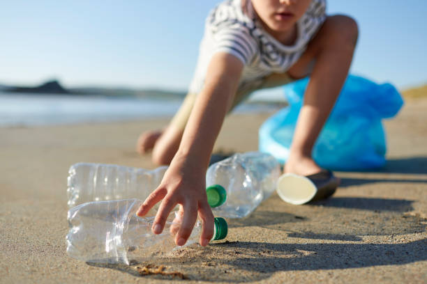 istock Child activist picking up abandoned water bottle 1439946151