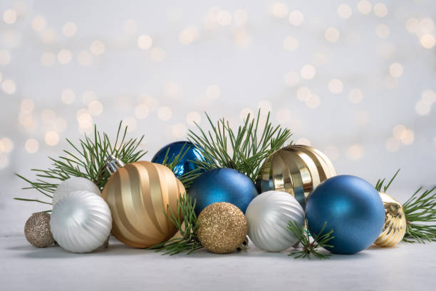 istock Christmas card with fir and decor on glitter background 1439946321