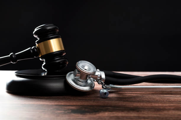 Gavel and stethoscope on wooden table