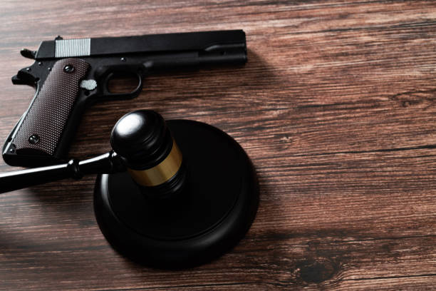 istock Gun and gavel on the table 1439947693