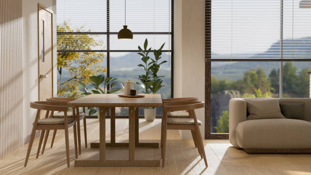 istock Minimal wood dining table set with sofa, home decor and amazing glass window in background. 1439948052