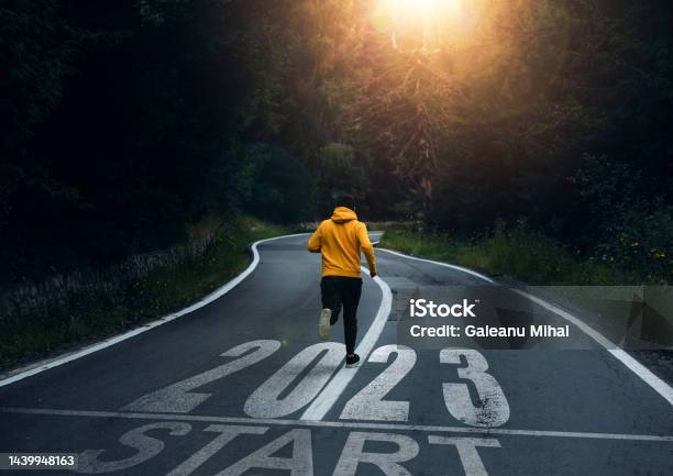 Man Running On The Mountain Road Towards New Goals In 2023 New Year 2023 With New Ambitions Challenge Plans Goals And Visions Stock Photo - Download Image Now