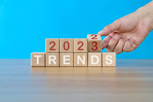 istock Hand turning  blocks from 2022 to 2023 with trends text 1439948378