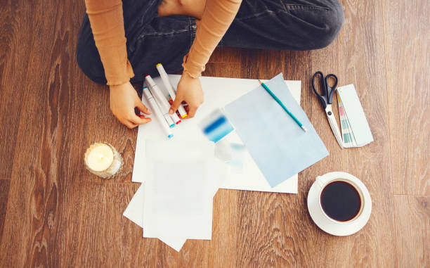 istock Young brunette african american woman creating her Feng Shui wish map using scissors 1439949426