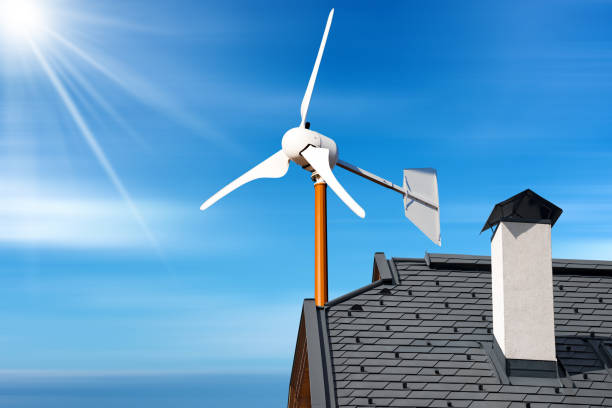 Small Wind Turbine on the top of a Roof of a House stock photo