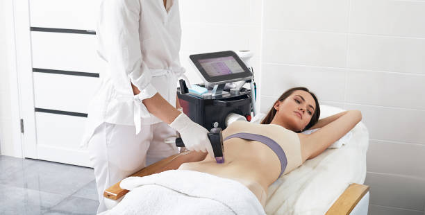 RF-lifting. Laser rejuvenation for female patient using cosmetic handpiece for radiofrequency body skin lifting at cosmetology clinic stock photo