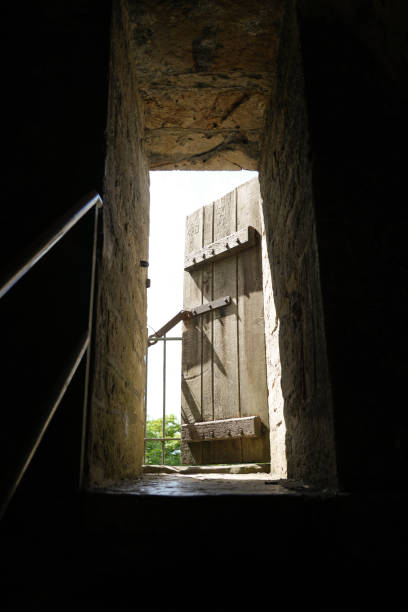 istock Old wooden door. Into the light from the darkness. 1439952136