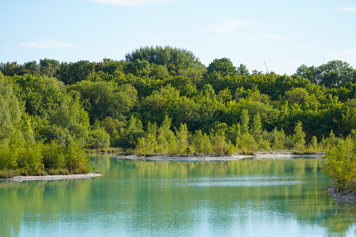 View of the Dyckerhoff lake in Beckum. Quarry west. Blue Lagoon. Landscape with a turquoise blue lake and the surrounding nature.