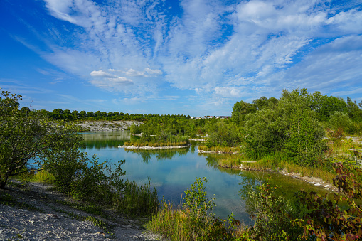 View of the Dyckerhoff lake in Beckum. Quarry west. Blue Lagoon. Landscape with a turquoise blue lake and the surrounding nature.