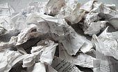 Close-up of many crumpled receipts from stores. The concept of shopping and purchases