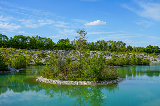 View of the Dyckerhoff lake in Beckum. Quarry west. Blue Lagoon. Landscape with a turquoise blue lake and the surrounding nature.